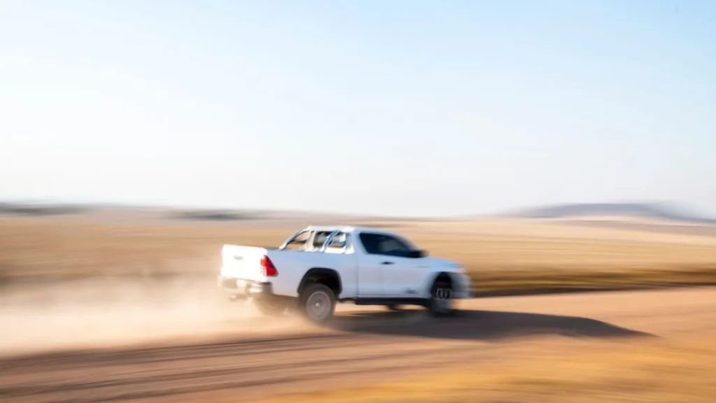 Toyota Hilux driving in sand